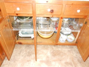 Wire shelves with glass bowls and dishes let plenty of light through to the bottom shelf.